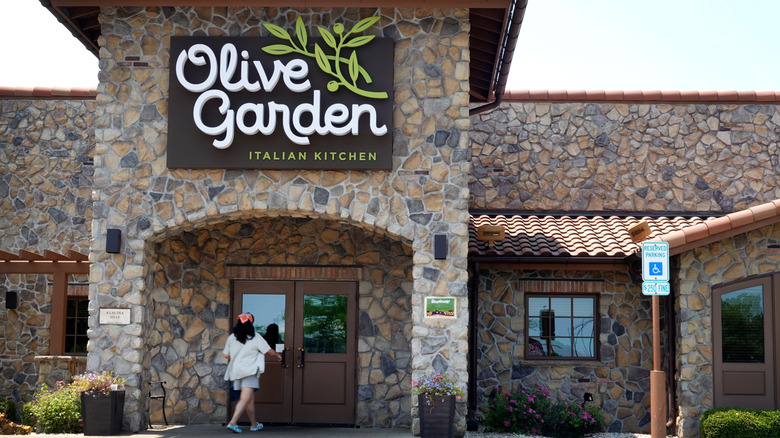Person walking into Olive Garden restaurant