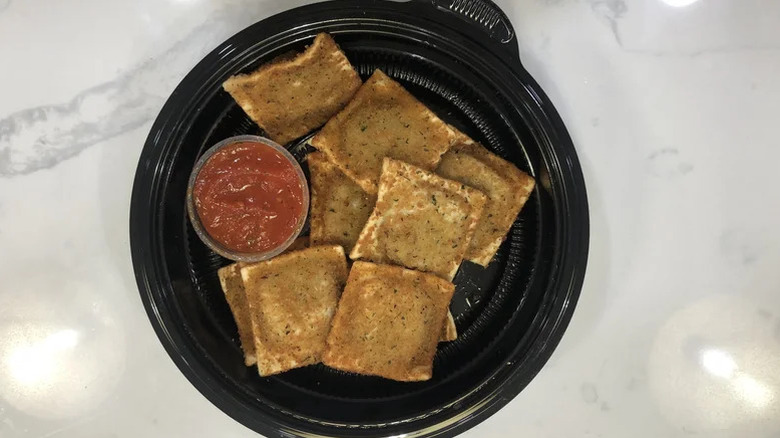 Top view of toasted ravioli in a take out container