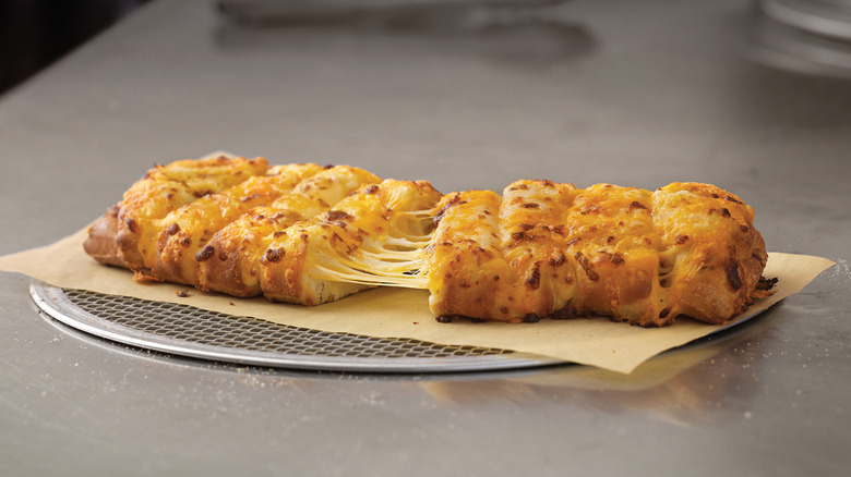 Domino's stuffed cheesy bread on piece of parchment paper