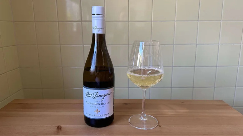 Glass of Domaine Henri Bourgeois Petit Bourgeois Sauvignon Blanc on wooden table