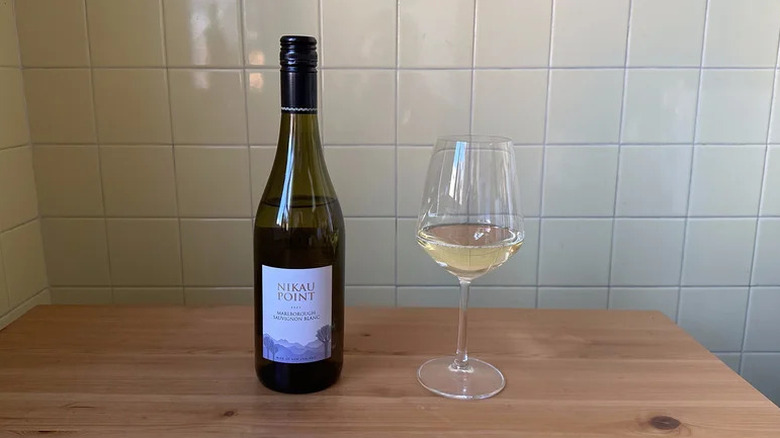 Glass of Nikau Point Marlborough Sauvignon Blanc on wooden table