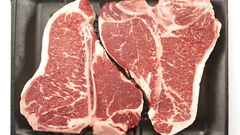 Two Member's Mark USDA Choice Angus beef loin T-bone steaks in a black tray