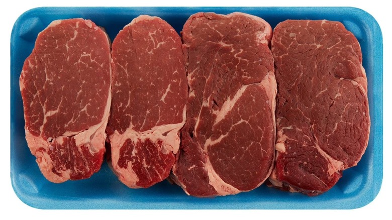 Four Member's Mark USDA Prime Angus beef filet mignons in a blue tray