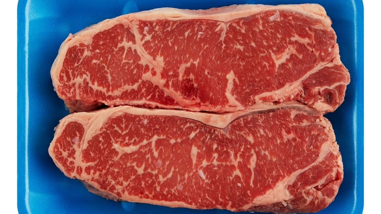Two Member's Mark USDA Prime beef strip steaks in a blue tray