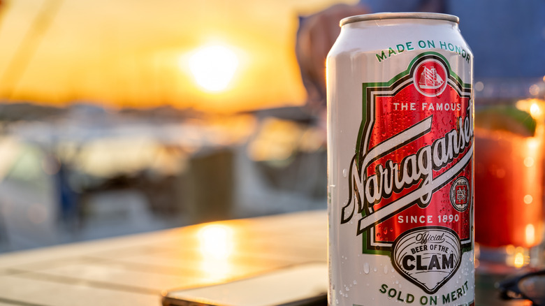 Can of Narragansett lager on a beach in front of the sunset