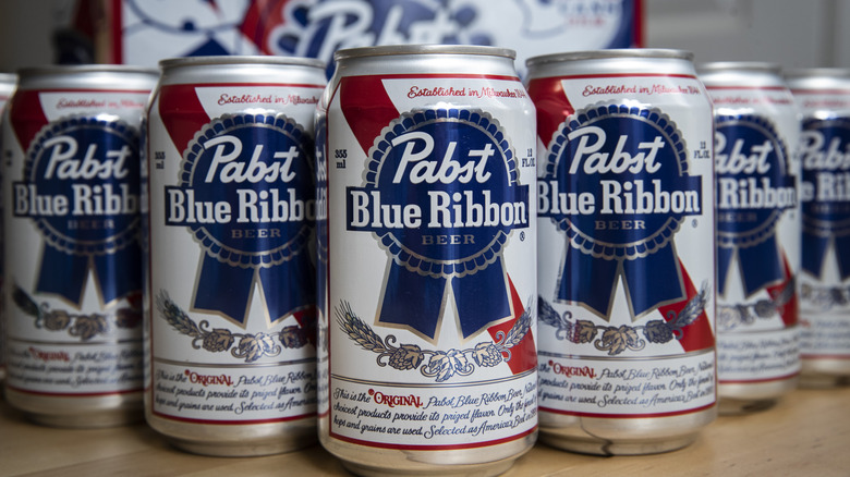 Cans of PBR stacked in a V shape.