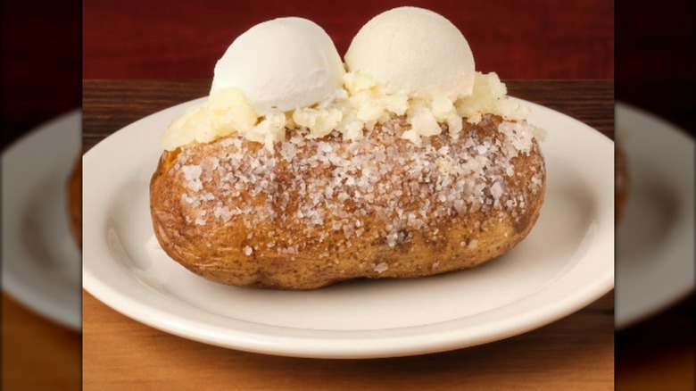 baked potato with large mounds of butter on top from Texas Roadhouse