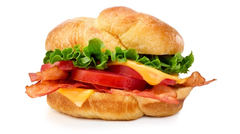 BLT and cheese croissant on white background