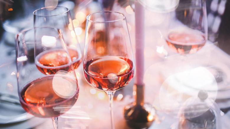 Glasses of rose wine at candle lit table