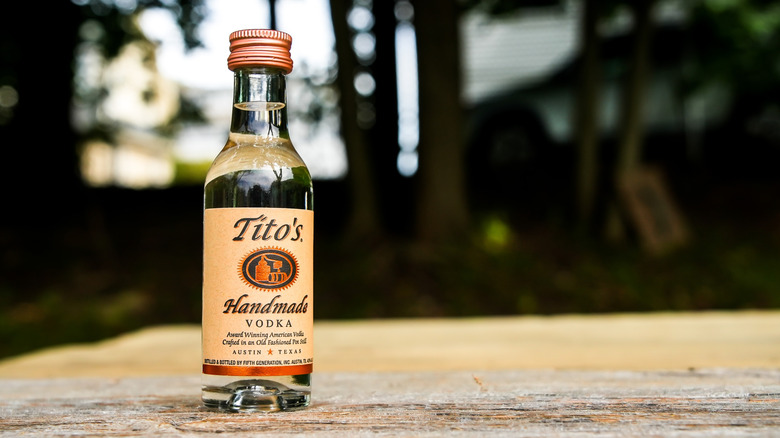 Tito's Vodka bottle on a table outdoors
