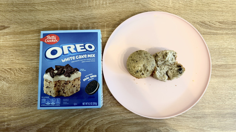 Left: a box of Oreo cake mix; right: two Oreo cupcakes, one halved