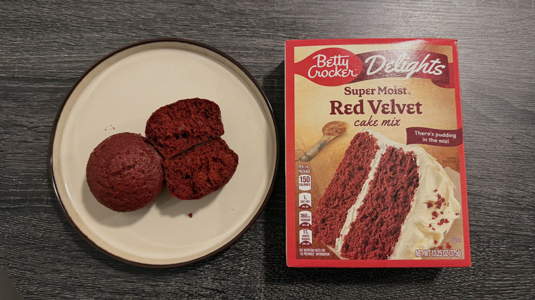 Left: two red cupcakes, one halved; right: a box of cake mix