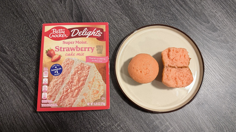Left: a box of cake mix; right: two pink cupcakes, one halved
