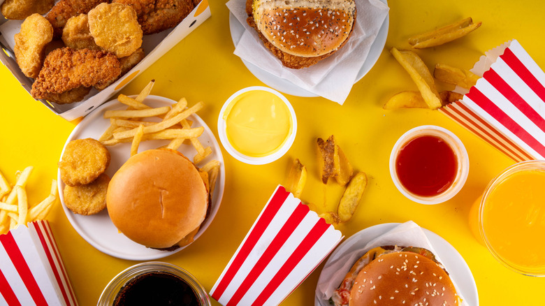 An aerial shot of several fast food food items on a yellow table