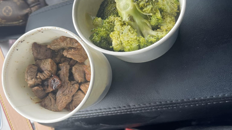 Kids' meal from Texas Roadhouse in to-go containers in car