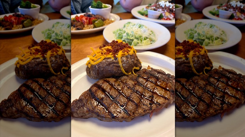 Steak and baked potato on white plate at Texas Roadhouse