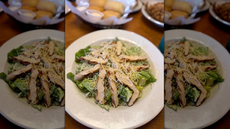 Chicken Caesar salad on white plate at Texas Roadhouse