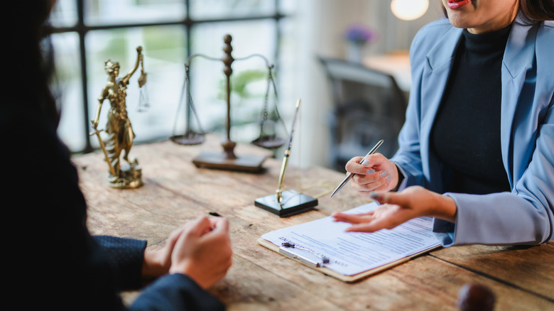 Lawyer showing contract details to client during a meeting