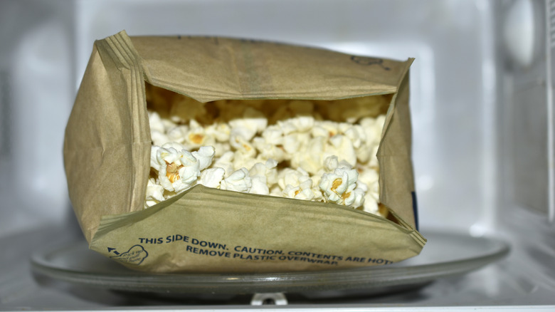 A bag of popcorn in the microwave