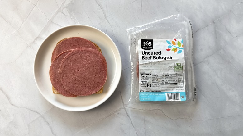 sliced bologna on bread with package of 365 bologna alongside