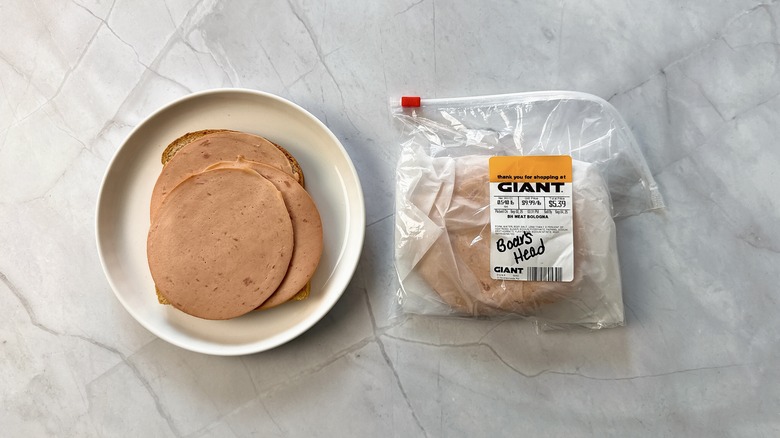 sliced bologna on bread with package of Boar's head bologna alongside