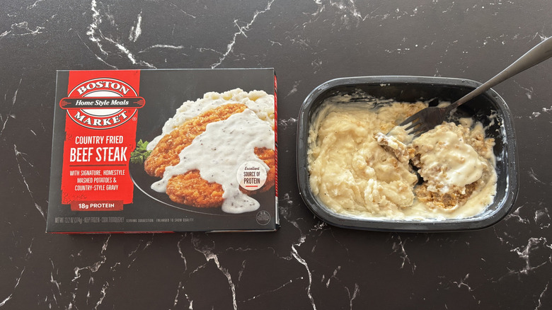Boston Market country fried beef steak package next to country fried steak frozen meal tray