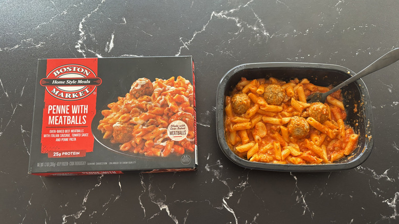 Boston Market penne with meatballs package next to penne with meatballs frozen meal tray
