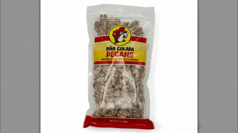 A bag of candied piña colada pecans from Buc-ee's isolated on a white background