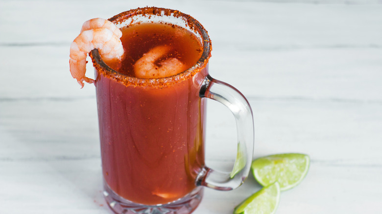 Glass stein with beer and clamato juice garnished with shrimp