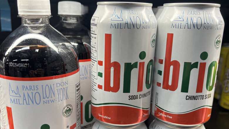 Plastic bottle and cans of Brio in grocery store