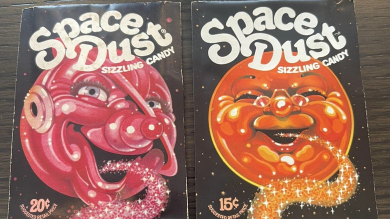 two packets of Space Dust on brown table
