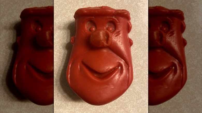Fred Flintstone red plastic coin holder toy