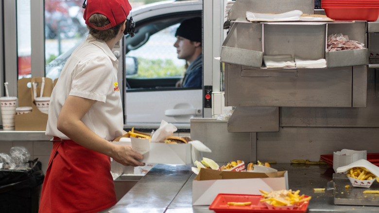 In-N-Out Burger drive thru window with employee