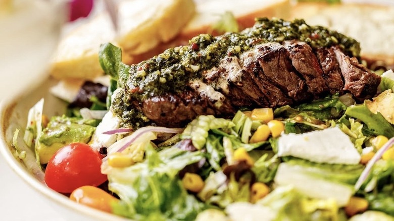 salad with a steak on it
