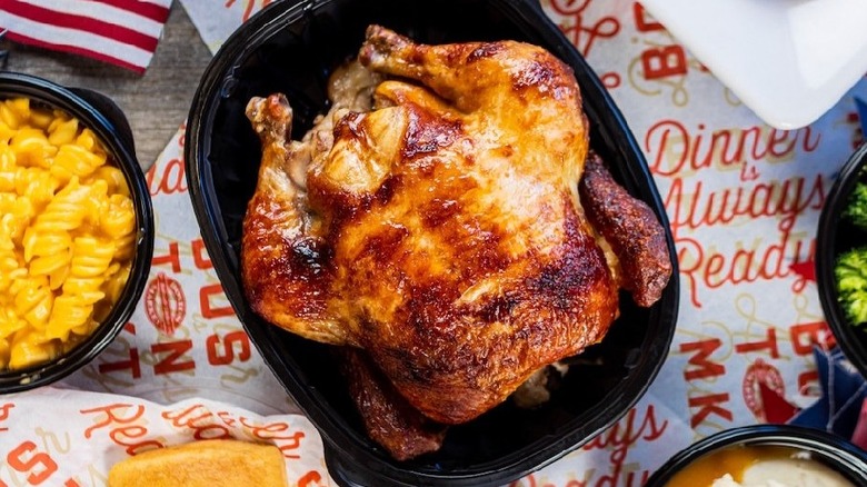 Boston Market rotisserie chicken in black to-go container