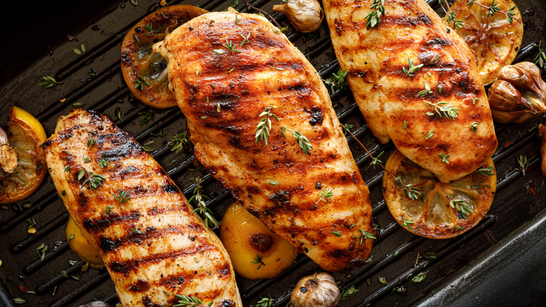 Grilled chicken breasts on grill with grill marks