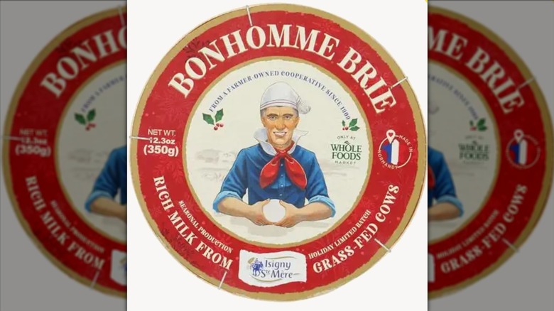 Wheel of Isigny Ste Mere Double Cream Brie on white background