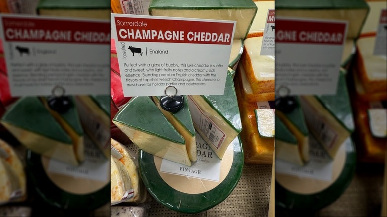 Wedges of Somerdale Champagne Cheddar with sign at store