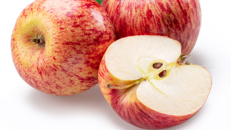 Honeycrisp apples against a white background
