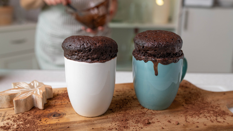 Microwave mug cakes on cutting board