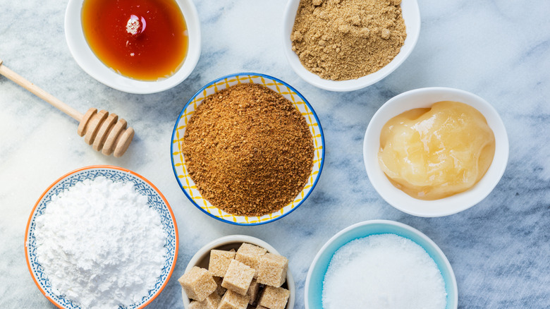 Different types of sugar, including honey, sugar, and artificial sweeteners