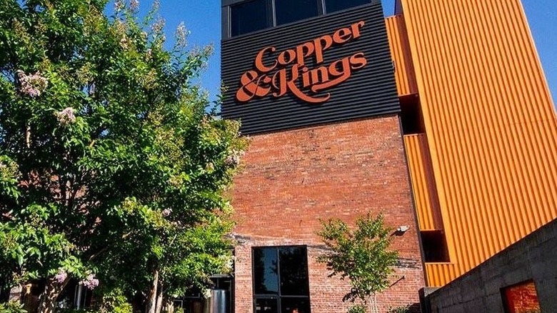 A contemporary building with a Copper & Kings sign