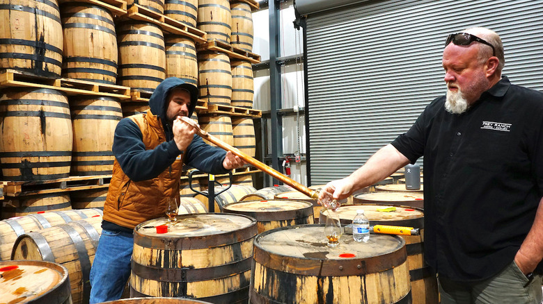 A distillery tour with whiskey barrels