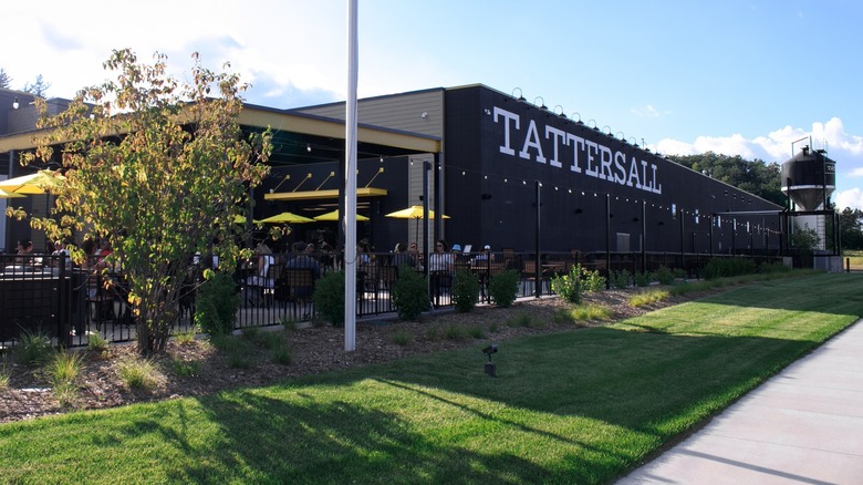 A Tattersall distillery with a green lawn