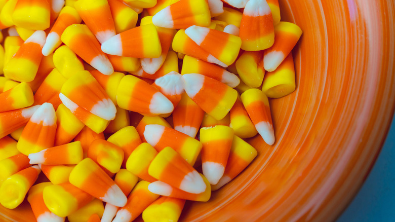 Pieces of candy corn in orange bowl