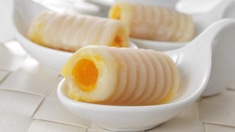 Huesos de santo marzipan treats in white dishes