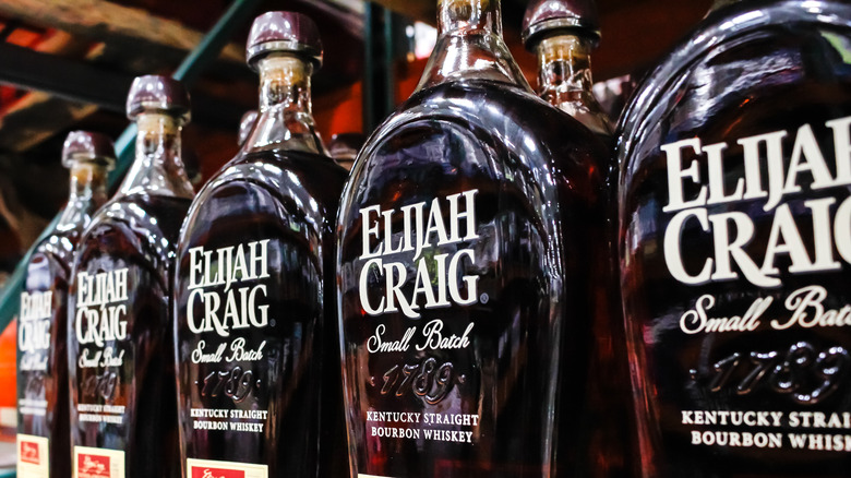 Bottles of Elijah Craig Small Batch whiskey lined up on a shelf