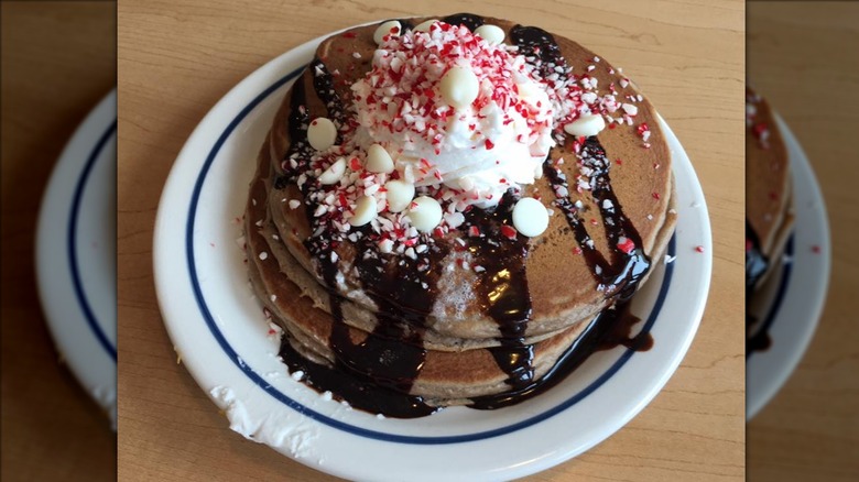 Dark chocolate peppermint pancakes stacked on white and blue plate