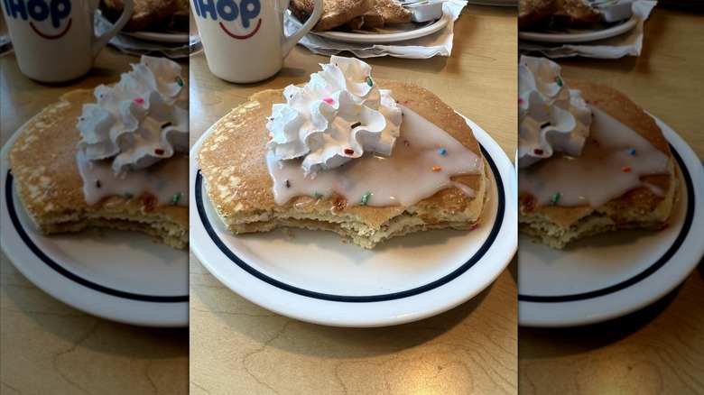 Cupcake pancakes with whipped cream on white plate