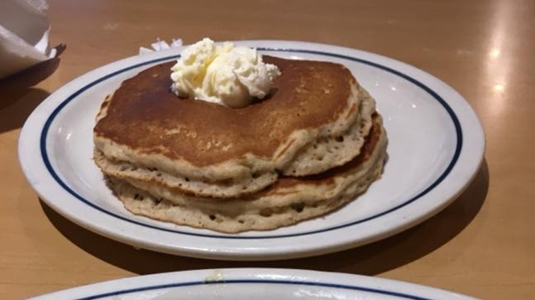 Harvest grain and nut pancakes stacked on white plate